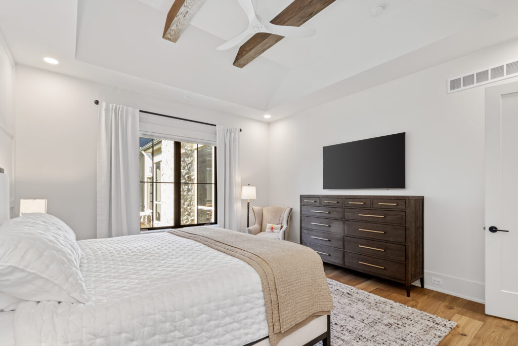 master primary bedroom rustic beams wood floor